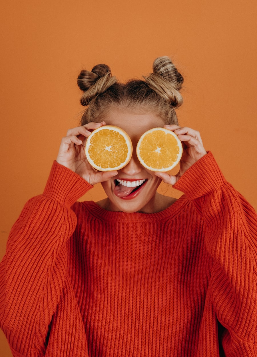 Woman in a red sweater holding a lemon